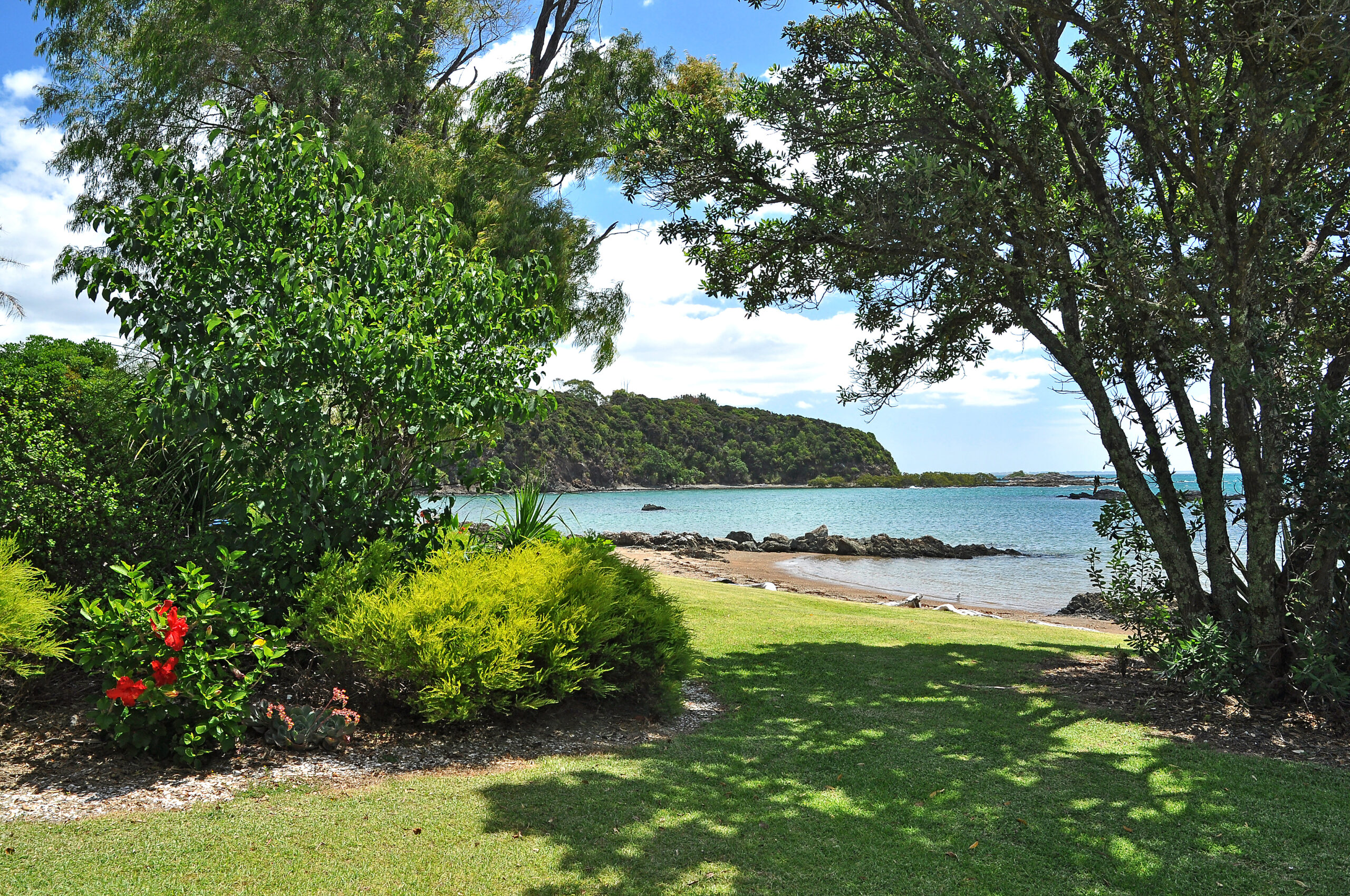 Landscaped gardens down to the waters edge and private waterfront coopers beach area